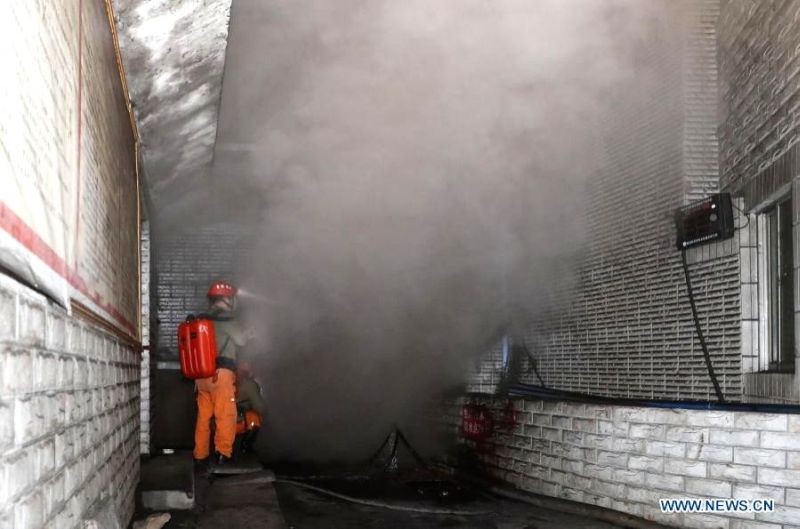 A rescuer gauges the density of carbon monoxide in the smog at the coal mine accident site in Yongchuan District of Chongqing, southwest China, Dec. 4, 2020. Eighteen miners were confirmed dead due to excessive level of carbon monoxide in a coal mine. ( IANS Photo)
