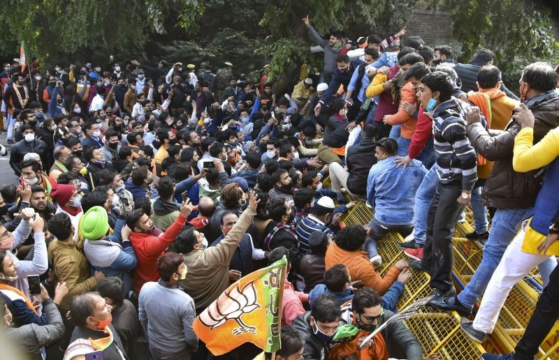 New Delhi: BJP workers stand on barricades during a protest against AAP government, at Vidhan Sabha in New Delhi, Thursday, Dec. 17, 2020. (PTI Photo)