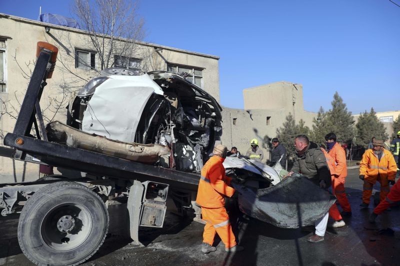 Afghan security personnel and municipality workers remove a damaged vehicle after a roadside bomb in Kabul, Afghanistan on December 22, 2020. A roadside bomb tore through a vehicle in the Afghan capital of Kabul Tuesday, killing multiple people, police said. (AP/PTI Photo)
