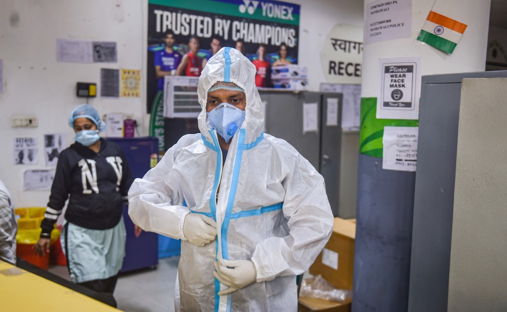 A medic wears a PPE kit inside CWG village COVID-19 Care Centre near Akshardham, in New Delhi on December 25. Only eleven patients are left for treatment in the centre. (PTI Photo/ Manvender Vashist)