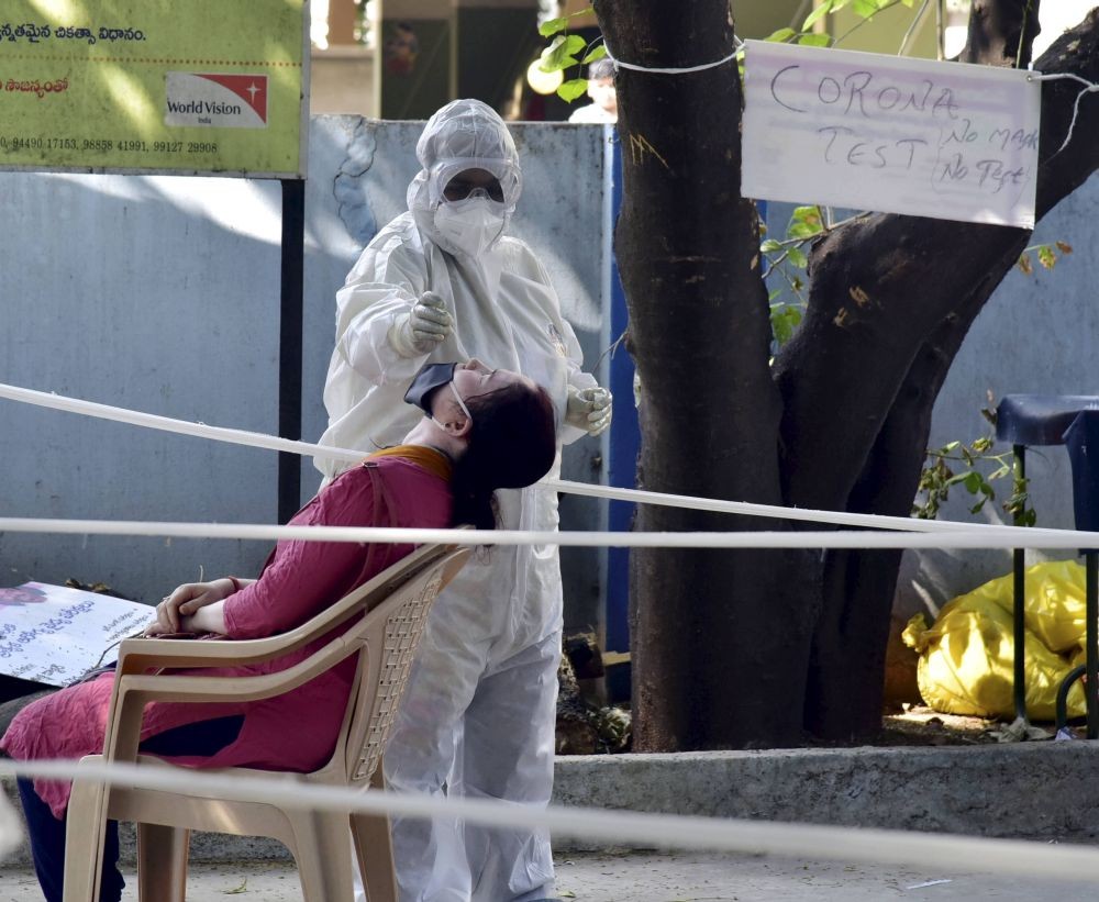 Hyderabad: A health worker collects a nasal sample from a woman for COVID-19 test, at a screening centre in Hyderabad, Sunday, Dec. 13, 2020. (PTI Photo)