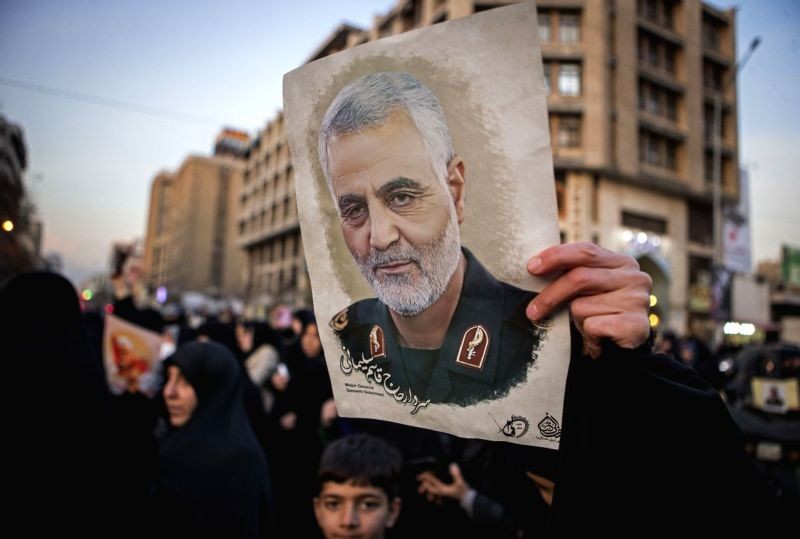A protestor holds a picture of Iranian commander Qasem Soleimani during a protest outside the British embassy in Tehran, Iran, January 12, 2020. (IANS File Photo)