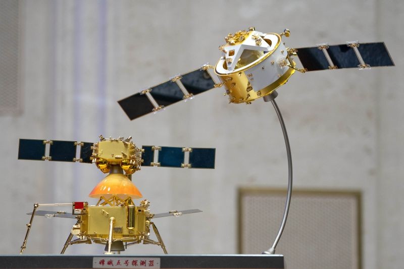 A model of China's Chang'e 5 lunar orbiter and lander are displayed before a press conference at the State Council Information Office in Beijing on December 17, 2020. Following the successful return of moon rocks by its Chang'e 5 robotic probe, China is preparing for future missions that could set the stage for an eventual Â lunar base to host human explorers. (AP/PTI Photo)