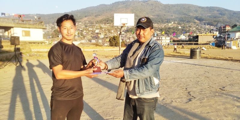 Khyolamo Humtsoe handing over the man of the match to Nzanthung Odyuo of Forest CC.