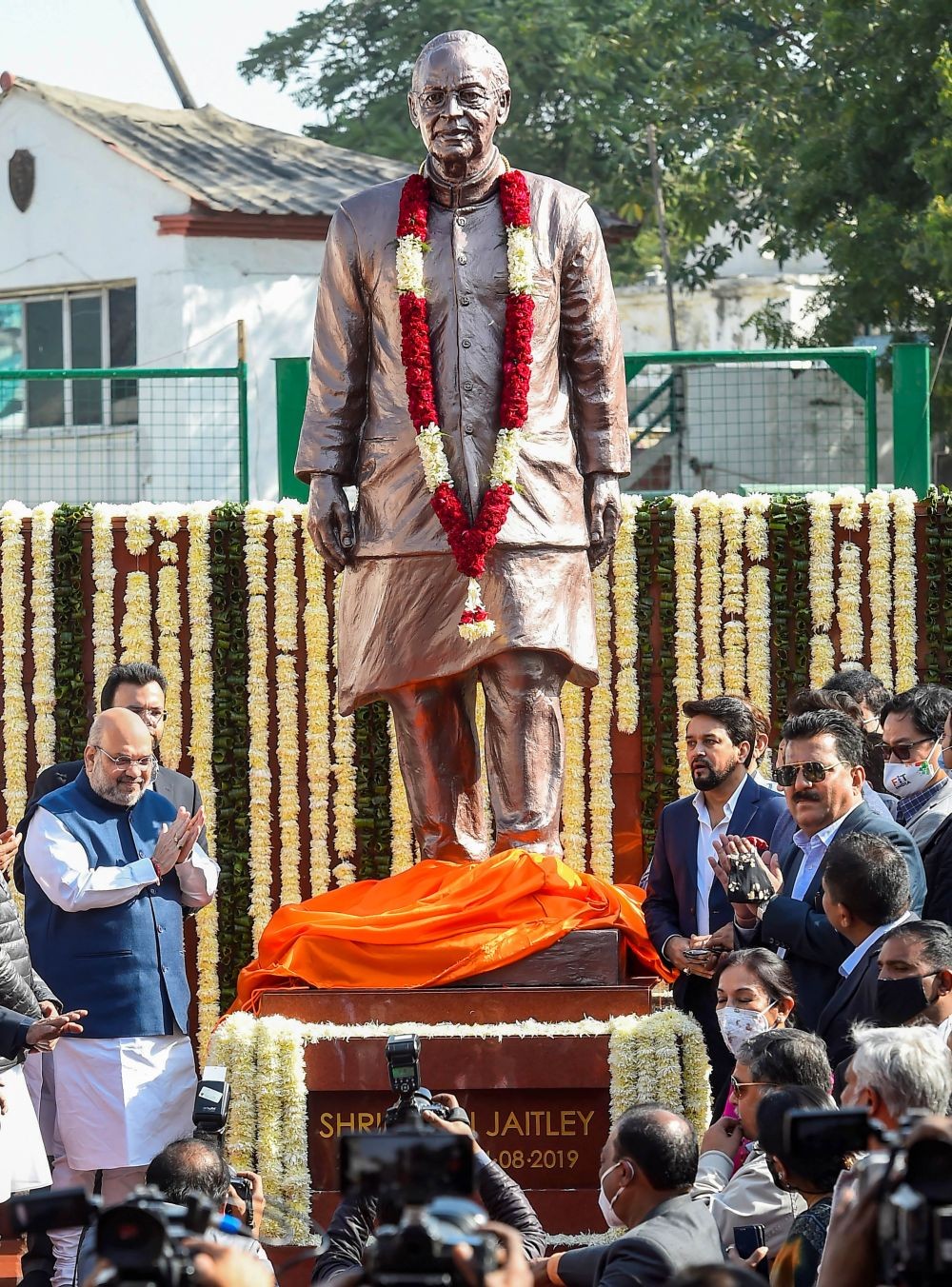 New Delhi: Home Minister Amit Shah unveils the statue of former union minister late Arun Jaitley on his birth anniversary, at Arun Jaitley Stadium in New Delhi, Monday, Dec. 28, 2020. DDCA President Rohan Jaitley is also seen.  (PTI Photo)