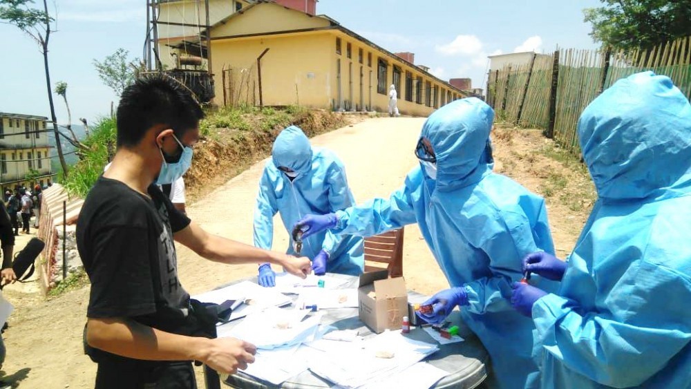 Frontline medical personnel registering returnees at the entrance of a quarantine centre in Kohima. Nagaland, with its limited resources, initially struggled to grapple with the novel coronavirus but subsequent improvement in health infrastructure helped the state administration to take effective measures to contain the pandemic(Morung File Photo)