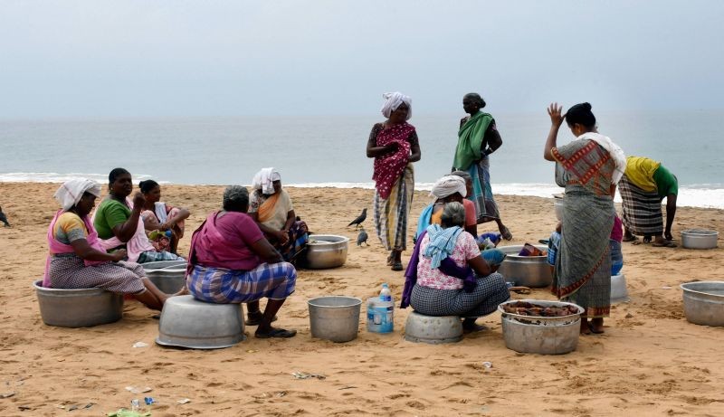 Thiruvananthapuram: Vendors wait for fishing boats to arrive amid Cyclone Burevi alert, at Valiyathura coast in Thiruvananthapuram, Friday, Dec. 4, 2020. (PTI Photo)