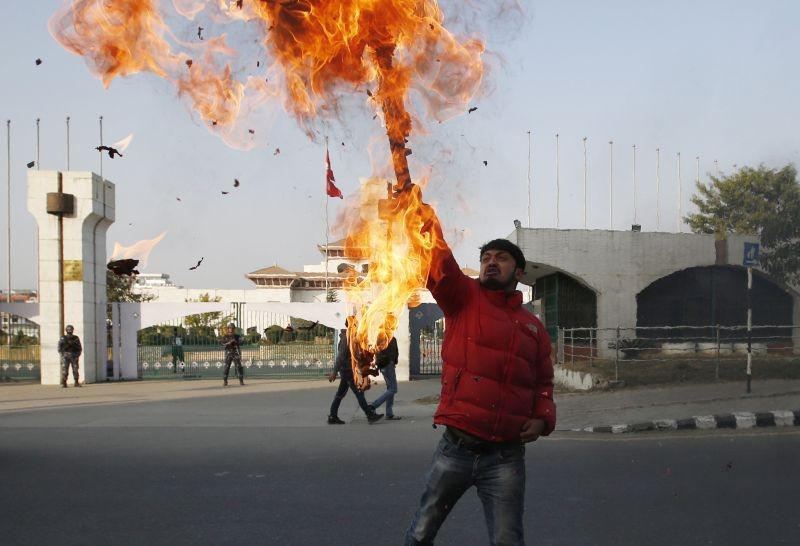 A Nepalese protester burns an effigy of prime minister Khadga Prasad Oli in front of the parliament building in Kathmandu, Nepal on December 20, 2020. Nepal's president dissolved Parliament on Sunday after the prime minister recommended the move amid an escalating feud within his Communist Party that is likely to push the Himalayan nation into a political crisis. Parliamentary elections will be held on April 30 and May 10, according to a statement from President Bidya Devi Bhandari's office. (AP/PTI Photo)