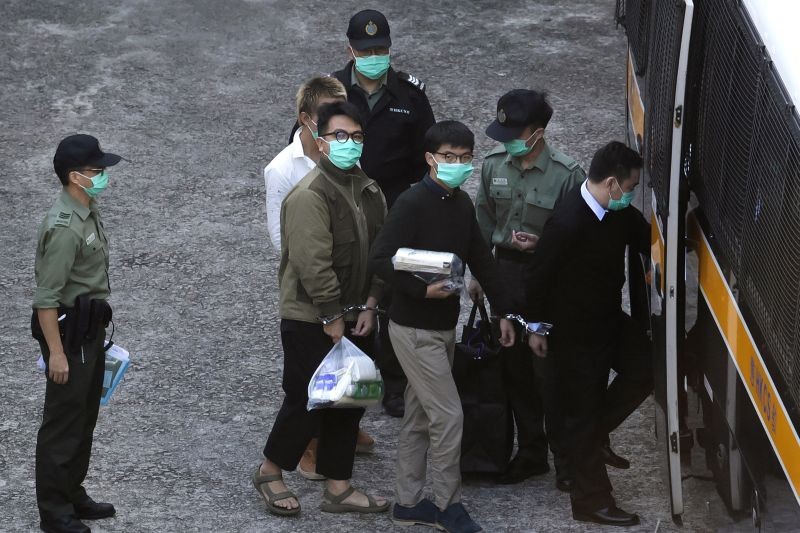 Hong Kong:Hong Kong activists Joshua Wong, right, and Ivan Lam, left, are escorted by Correctional Services officers for a prison van before appearing in a court, in Hong Kong, Wednesday, Dec. 2, 2020. Prominent Hong Kong pro-democracy activist Wong and two other activists, Lam and Agnes Chow, were taken into custody after they pleaded guilty to charges related to a demonstration outside police headquarters during anti-government protests last year. (AP/PTI Photo)