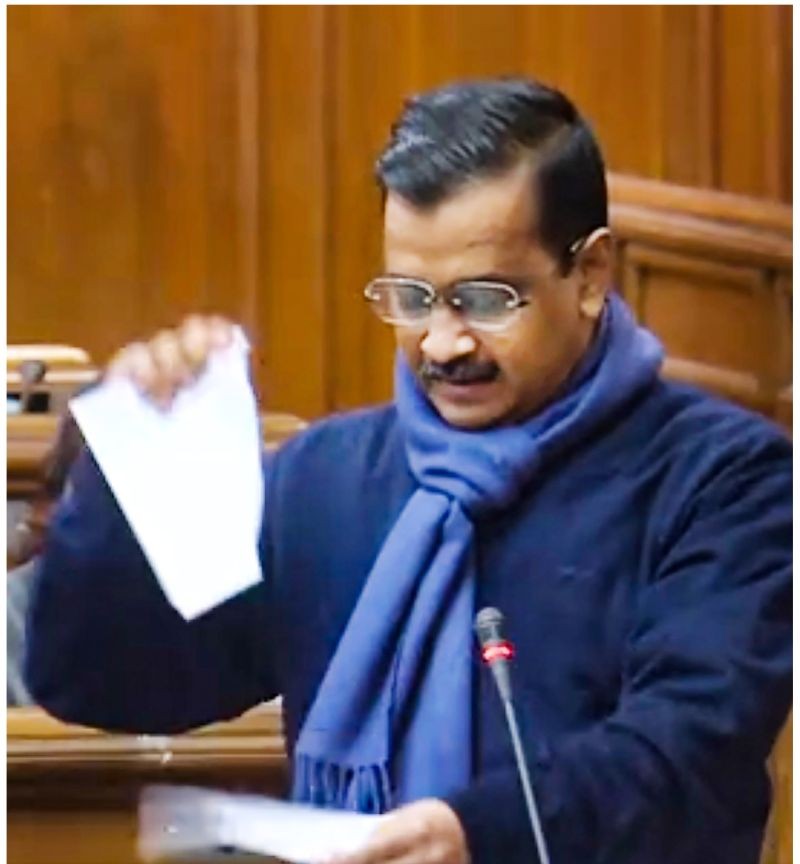 Delhi Chief Minister Arvind Kejriwal tears copies of new farm laws as he speaks at Delhi Legislative Assembly, in New Delhi on December 17. (PTI Photo)