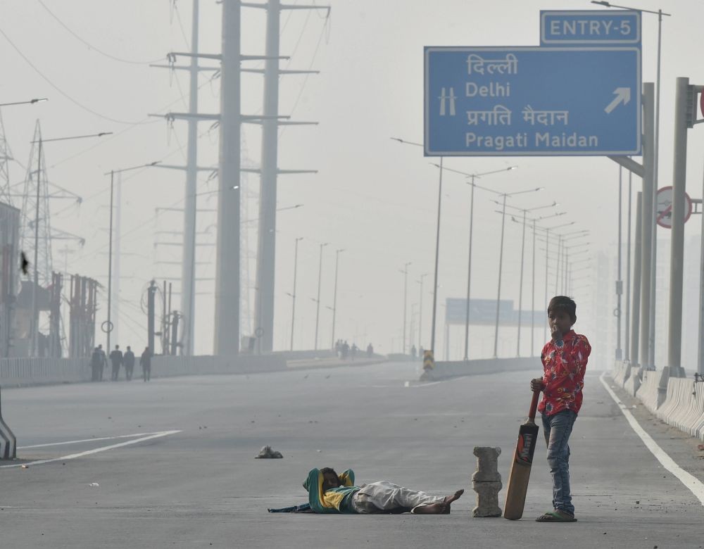 New Delhi: Children play cricket on NH-9 road, which is closed due to farmers' protest over the Centre's new farm laws, at Delhi-Noida border near Ghazipur, in New Delhi, Saturday, Dec. 5, 2020. (PTI Photo/Manvender Vashist) 