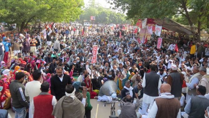 Farmers participate in a hunger strike during their protest against Centres farm reform laws, in Hisar district, on Monday. Photograph: PTI Photo