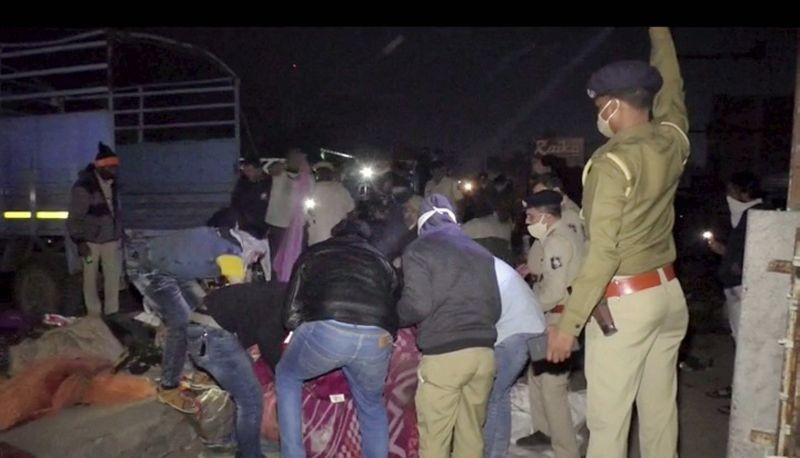 Police and locals carry out rescue operation after a truck ran over migrant labourers from Rajasthan sleeping by the roadside, shortly after midnight, near Surat on January 19, 2021. (PTI Photo)
