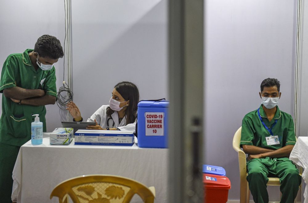 Mumbai: Medics staff sit inside a vaccination booth at BKC in preparation for the first round of COVID vaccination drive scheduled to begin across the country from January 16, in Mumbai, Friday, Jan. 15, 2021. (PTI Photo/Kunal Patil)(