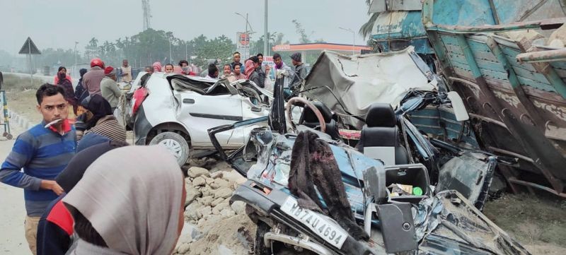 Locals present at the spot where a stone-laden truck and three vehicles collided on Tuesday night, in Jalpaiguri on January 20, 2021. Fourteen members, including four children, of a marriage party were killed and 10 others injured in the accident. (PTI Photo)