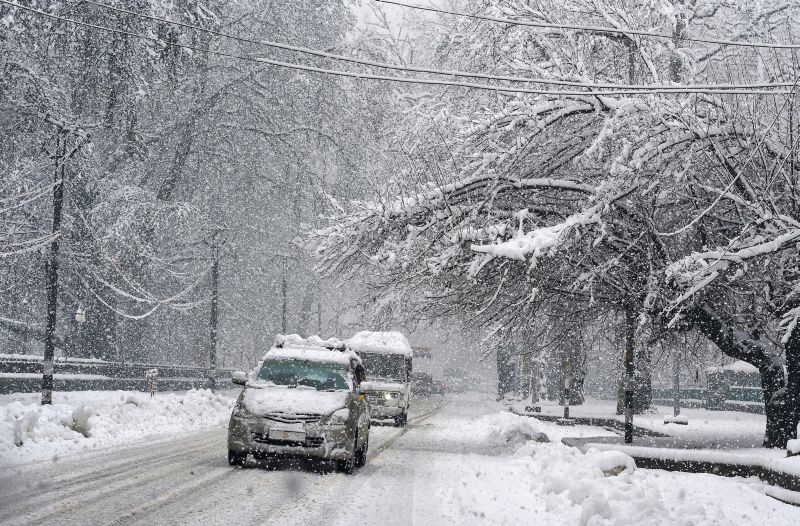 Srinagar: Vehicles move slowly on a snow-covered road during heavy snowfall, in Srinagar, Tuesday, Jan. 5, 2021. (PTI Photo/S. Irfan)