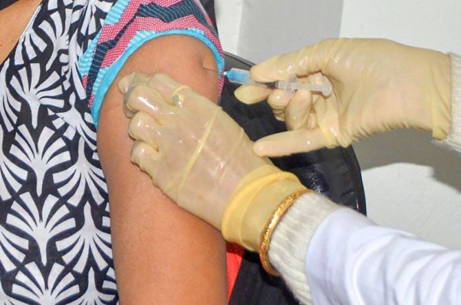 A medic administers the first shot of COVID-19 vaccine to a frontline worker. Photograph: PTI Photo