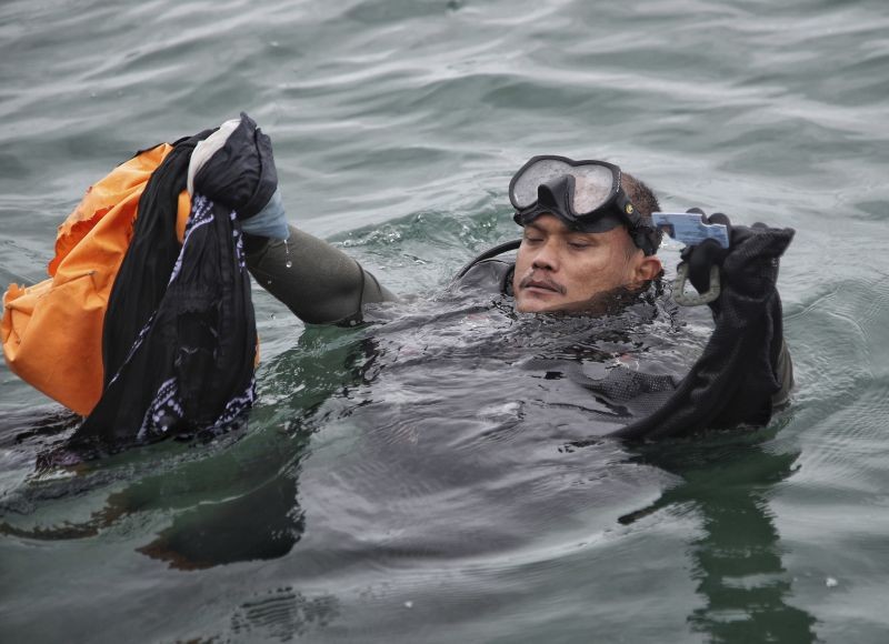 An Indonesian Navy diver shows debris recovered from the water during a search operation for a Sriwijaya Air passenger jet that crashed into the sea near Jakarta, Indonesia on January 10, 2021. Indonesian divers on Sunday located parts of the wreckage of the Boeing 737-500 at a depth of 23 meters (75 feet) in the Java Sea, a day after the aircraft with dozens of people onboard crashed shortly after takeoff from Jakarta. (AP/PTI Photo)