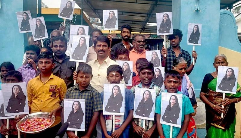Villagers hold portraits of U.S. Vice President-elect Kamala Harris after participating in special prayers ahead of her oath taking ceremony, at Thulasendrapuram- hometown of Harris' maternal grandfather, in Tiruvarur district on January 20, 2021. (PTI Photo)