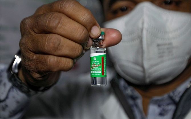 A health worker shows the Covishield vaccine, after arrival of the first batch of the vaccines from the Serum Institute of India at the Civil Hospital, in Ahmedabad, on Tuesday. Photograph: PTI Photo