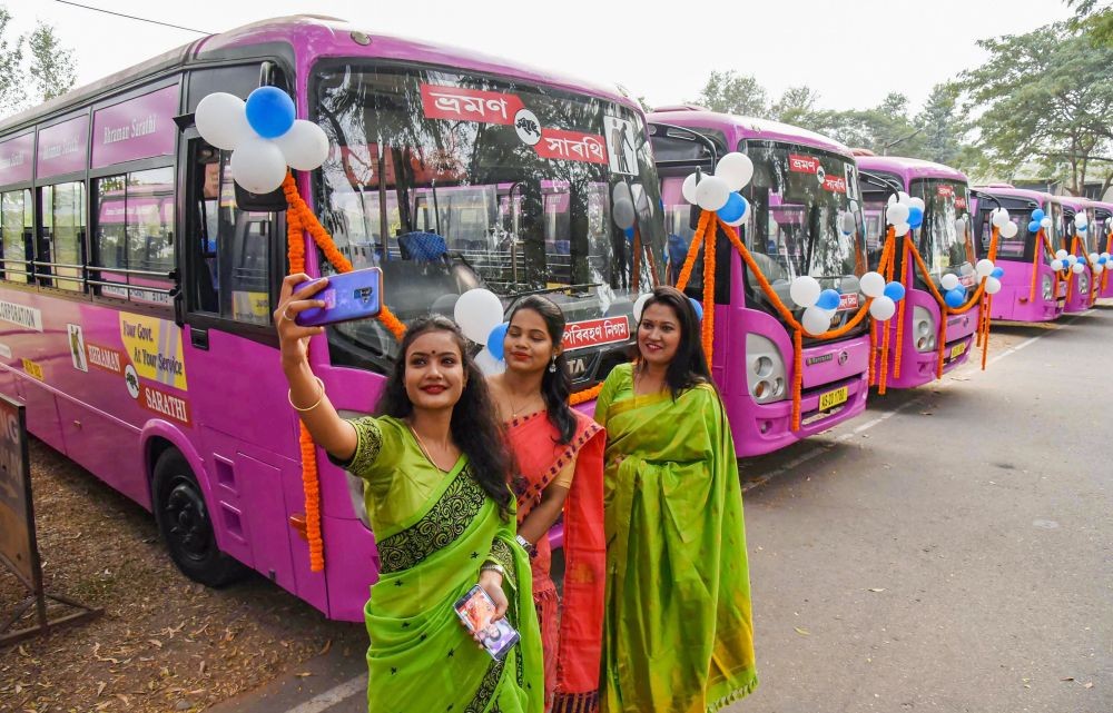 Guwahati: Women take selfies during the launch of pink city buses for women and senior citizens under the Bhraman Sarathi scheme, at Khanapara in Guwahati, Saturday, Jan. 09, 2021. (PTI Photo)
