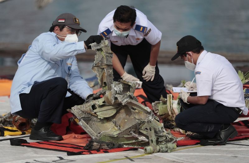 Investigators inspect a pieces of the Sriwijaya Air flight SJ-182 retrieved from the Java Sea where the passenger jet crashed on Jan. 9, at Tanjung Priok Port in Jakarta, Indonesia on January 21, 2021. Indonesian authorities on Thursday ended the search for the wreckage of the plane that nosedived into the sea, killing all of its passengers on board. (AP/PTI Photo)