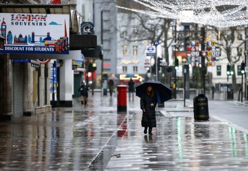 A woman walks on an empty street near Leicester Square in London, Britain, on December 21, 2020. (IANS File Photo)