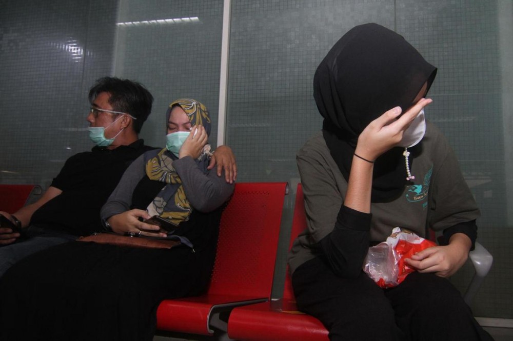 Relatives of passengers on board missing Sriwijaya Air flight SJY182 wait for news at the Supadio airport in Pontianak on Indonesia's Borneo island, after contact with the aircraft was lost shortly after take-off from Jakarta. AFP