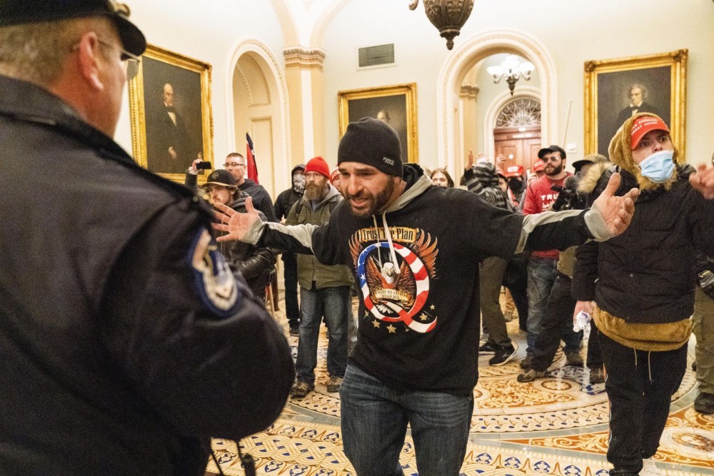 Supporters of President Donald Trump are confronted by Capitol Police officers outside the Senate Chamber at the Capitol January 6 in Washington. (AP/PTO Photo)