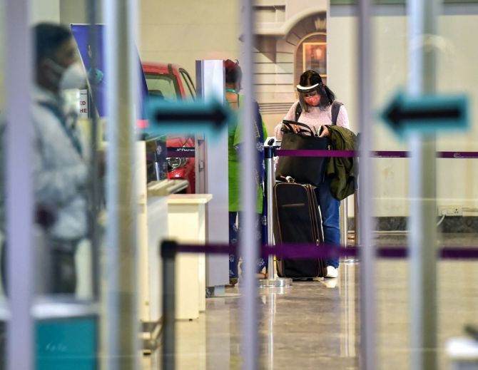 A traveller wearing face mask, as precautionary measure against the coronavirus pandemic, arrives at Kempegowda International Airport in Bengaluru. Photograph: Shailendra Bhojak/PTI Photo