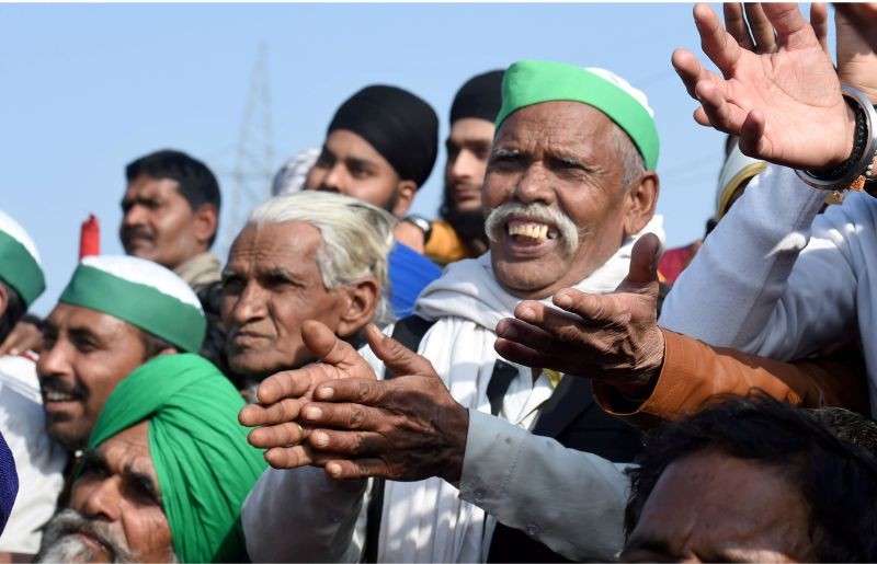 Farmers watch a wrestling competition during their protest against the new farm laws, at the Ghazipur border in New Delhi on January 10. (PTI Photo)