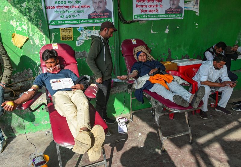 Farmers donate blood during their ongoing agitation over the farm reform laws, at Singhu border in New Delhi on January 11. (PTI Photo)