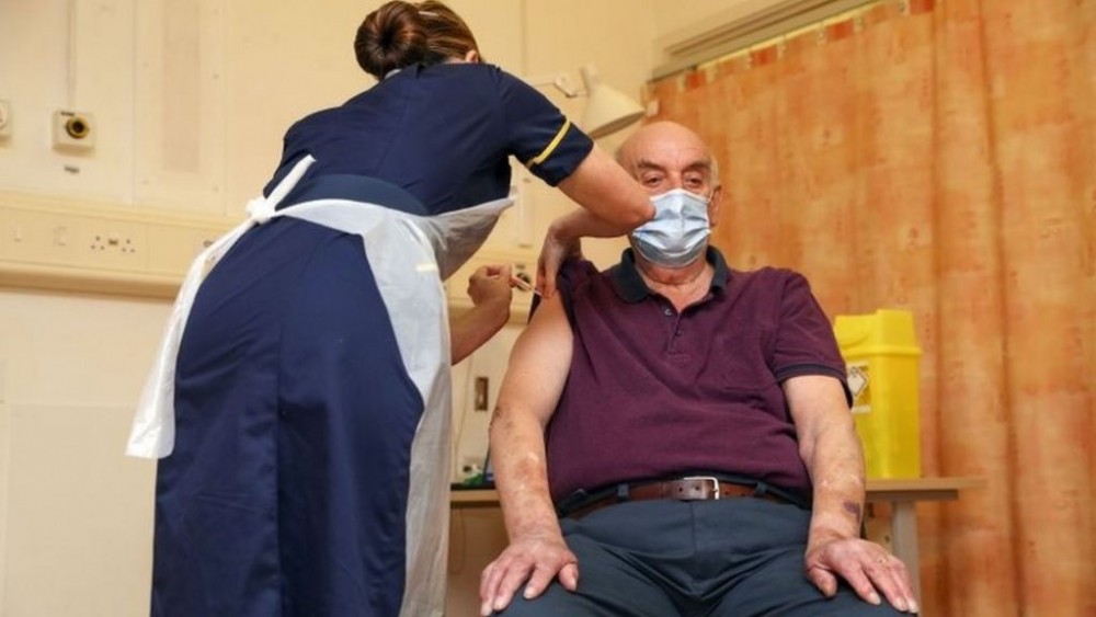 Brian Pinker, 82, receives the Oxford/AstraZeneca COVID-19 vaccine from chief nurse Sam Foster at Churchill Hospital in Oxford, England, on Jan. 4, 2021. Pinker, a dialysis patient and retired maintenance manager, was the first in the United Kingdom to receive the newly approved vaccine, which was developed by England's University of Oxford and British-Swedish pharmaceutical giant AstraZeneca. (AP Photo)