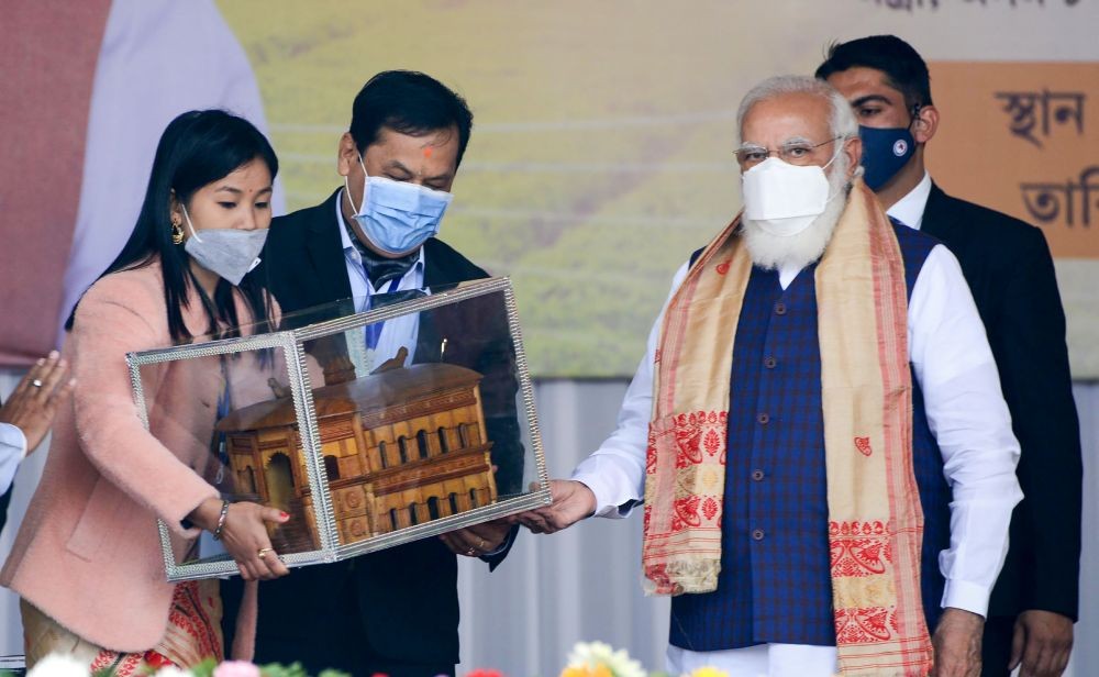 Sivasagar: Prime Minister Narendra Modi being felicitated with a memento during a public meeting, at Jerenga Pathar in Sivasagar District of Assam, Saturday, Jan. 23, 2021. (PTI Photo)