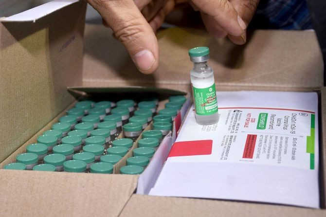 An official checks a box of COVID-19 vaccination at Civil Hospital in Surat. Photograph: PTI Photo