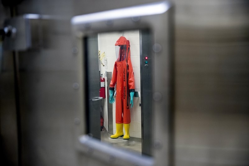 FILE - In this March 19, 2020, file photo, a biosafety protective suit for handling viral diseases are hung up in a biosafety level 4 training facility at U.S. Army Medical Research and Development Command at Fort Detrick in Frederick, Md., where scientists are working to help develop solutions to prevent, detect and treat the coronavirus. China is trying to spread doubt about the effectiveness of Western vaccines and the origin of the coronavirus as a World Health Organization-selected team of scientists are in the city where the pandemic first broke out. (AP Photo/Andrew Harnik, File)