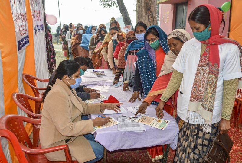 Mirzapur: Anganwadi workers stand in a queue as they wait for their turn to get vaccinated during the COVID-19 vaccination drive, at a government hospital in Mirzapur, Thursday, Jan. 28, 2021. (PTI Photo)