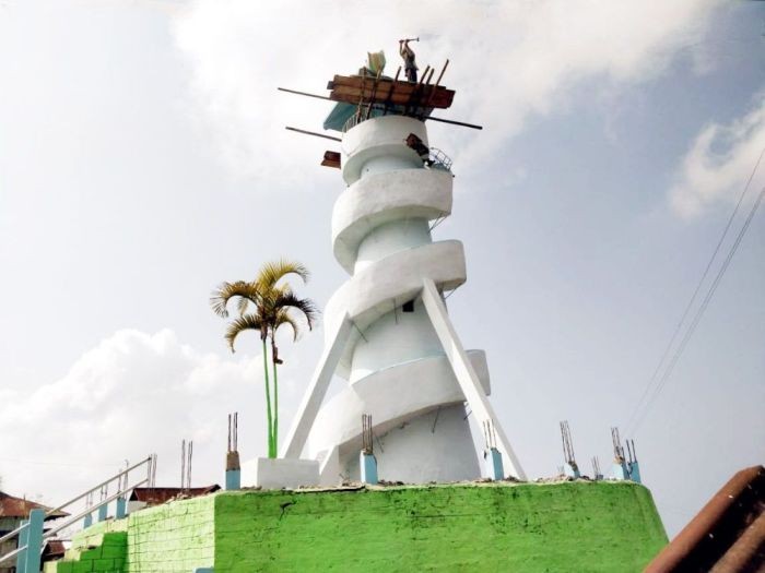 A worker atop the Etiben Memorial Tower at Mopungchuket village, Mokokchung on January 19. The Tower, built in 1972, is being dismantled to make way for a new one in its place. (Morung Photo)
