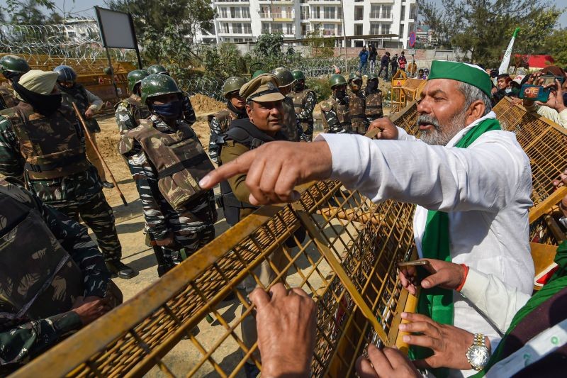 BKU leader Rakesh Tikait gestures towards security personnel who had blocked farmers' movement during their protest against Centre's farm laws, at Ghazipur border in New Delhi on February 6, 2021. (PTI Photo)