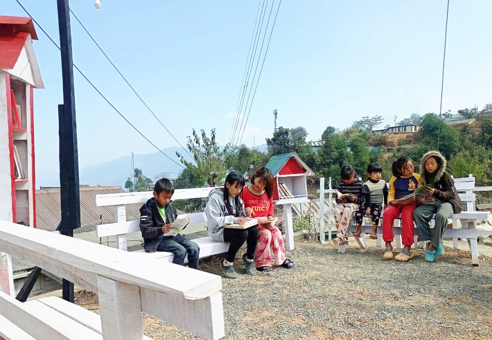 Children read books in the free street library in Phek. ‘Pick A Book’- a community based free street library project was inaugurated on January 30.