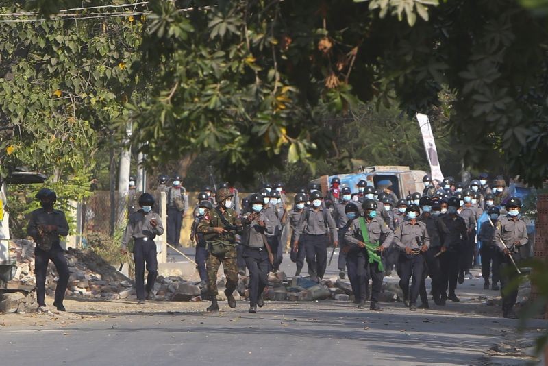 Myanmar riot police crossing blockage during a protest against the military coup in Mandalay, Myanmar on February 28, 2021. Security forces in Myanmar used lethal force as they intensified their efforts to break up protests a month after the military staged a coup. At least four people were reportedly killed on Sunday. (AP/PTI Photo)