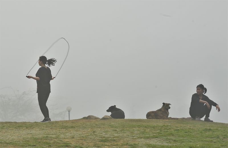 New Delhi: A young woman exercises in a park amid dense fog, in New Delhi, Saturday, Feb 20, 2021. (PTI Photo/Kamal Singh)