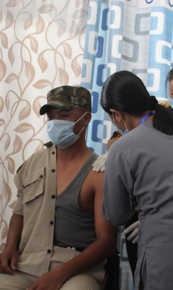 TOGETHER ON THE FRONTLINE: Healthcare worker, Owyan Phom is seen vaccinating her husband, a police personnel, at the Superintendent of Police Office, Longleng on February 16, in this photo shared by the District Media Officer Longleng, DoHFW, NHM on Twitter.  As of February 16, a total of 16,189 doses were administrated to the healthcare and frontline workers according to an official update. A total of 14,980 beneficiaries were given the first dose and 1209 have received  the 2nd dose. (Photo Courtesy Twitter/@NagalandNhm)