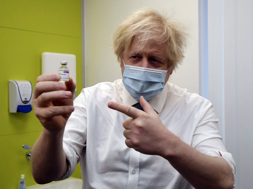 London:Britain's Prime Minister Boris Johnson holds a vial of the AstraZeneca vaccine during a visit to a coronavirus vaccination centre at the Health and Well-being Centre in Orpington, south-east London, Monday, Feb. 15, 2021. AP/PTI