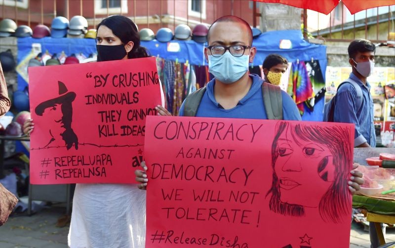 Members of various social organisation display placards during a protest against the arrest of climate activist Disha Ravi, in Bengaluru on February 15. Disha A. Ravi was arrested on Saturday by the Delhi Police in connection with the Greta Thunberg's 'toolkit' case. (PTI Photo)