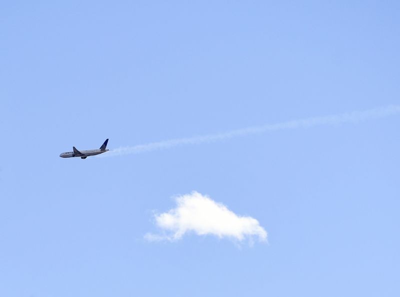 A United Airlines plane with smoke trailing from its right side is seen heading east towards Denver International Airport on February 20, 2021 in Broomfield, Colo . Debris from a United Airlines plane fell onto Denver suburbs during an emergency landing Saturday, with one very large piece that appears to be part of the engine narrowly missing a home. (AP/PTI Photo)
