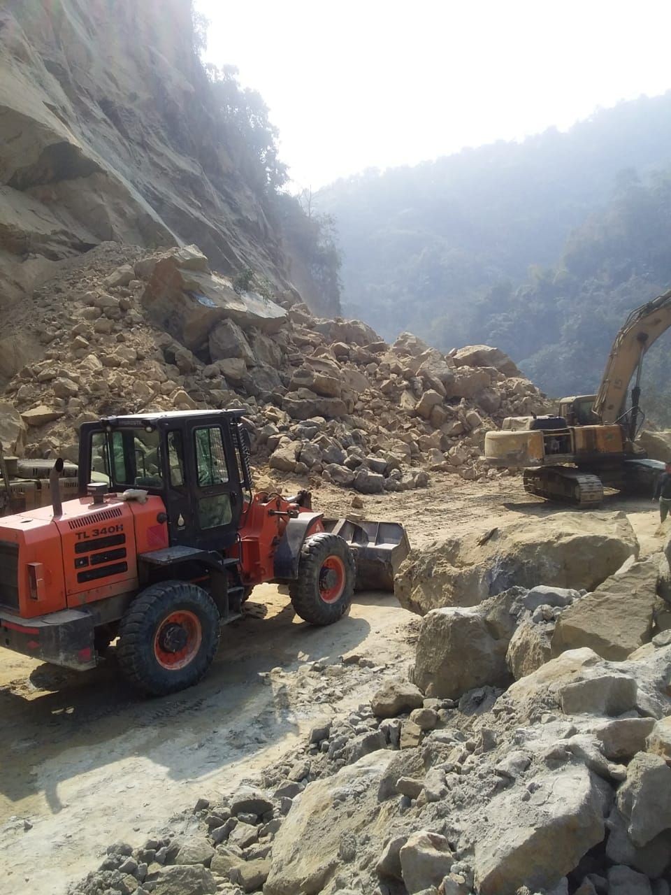Earth excavators clearing the debris after the rockslide in the New Chümoukedima segment of NH-29 on February 2 . (Photo Courtesy: Dimapur police)