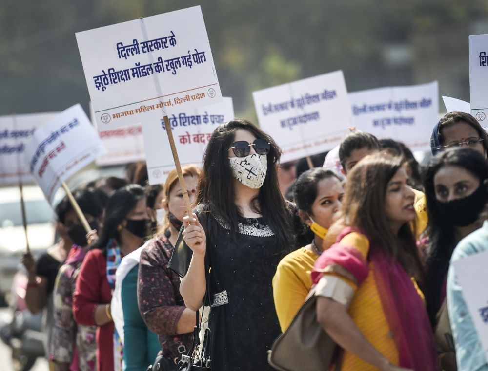 New Delhi: Members of BJP Mahila Morcha during a protest against Delhi Government's education policy, outside Delhi Deputy Minister Manish Sisodia's residence, in New Delhi, Thursday, Feb. 25, 2021.  (PTI Photo/Ravi Choudhary)