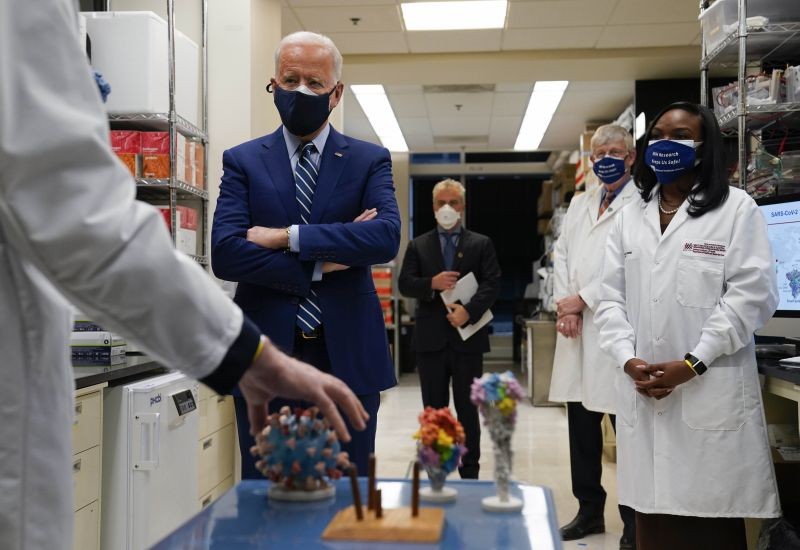 Dr. Barney Graham, left, speaks as President Joe Biden listens during a visit to the Viral Pathogenesis Laboratory at the National Institutes of Health (NIH) on February 11, 2021, in Bethesda, Md. Francis Collins, Kizzmekia Corbett, an immunologist with the Vaccine Research Center at the NIH, right, and NIH Director, second from right, listen. (AP/PTI Photo)