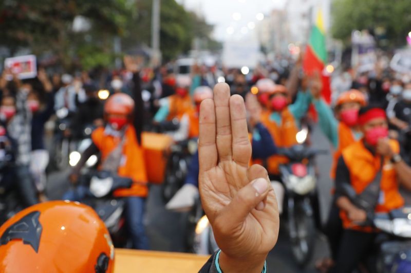 Protesters flash the three-fingered salute as they march in Mandalay, Myanmar, on  February 8. Tension in the confrontations between the authorities and demonstrators against last week's coup in Myanmar boiled over Monday, as police fired a water cannon at peaceful protesters in the capital Naypyitaw. (AP/PTI Photo)